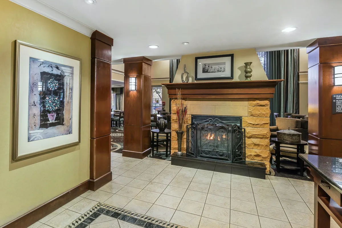 This image features a cozy dining area with a fireplace, artwork, and a welcoming atmosphere. The setting is perfect for enjoying home-cooked meals, intimate conversations, or relaxing with a warm drink.